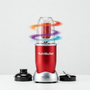 A vibrant, stainless steel Nutribullet blender is captured against a clean white backdrop, showcasing its sleek design and functionality. The blender is positioned upright, with its clear, BPA-free plastic cup attached to the base
